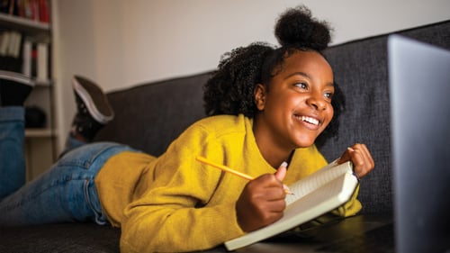 Young woman writing in a notebook